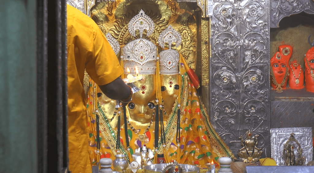 An image capturing the vibrant colors and spiritual ambiance of Shardiya Navaratri celebrations, where devotees honor the divine feminine energy through rituals and traditions